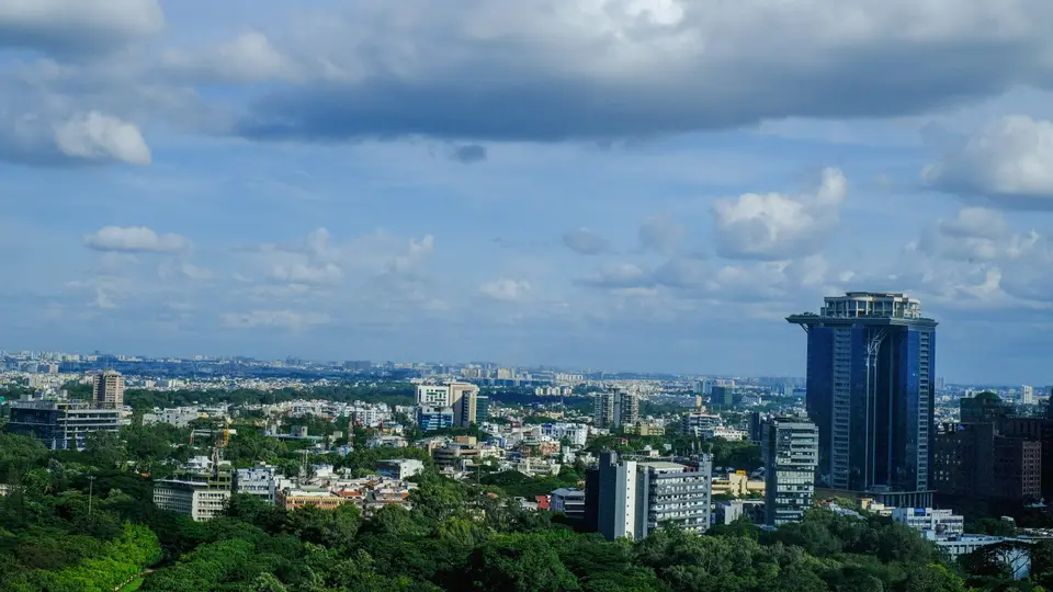 Bengaluru seen from above, high-rises rising out of tree cover.